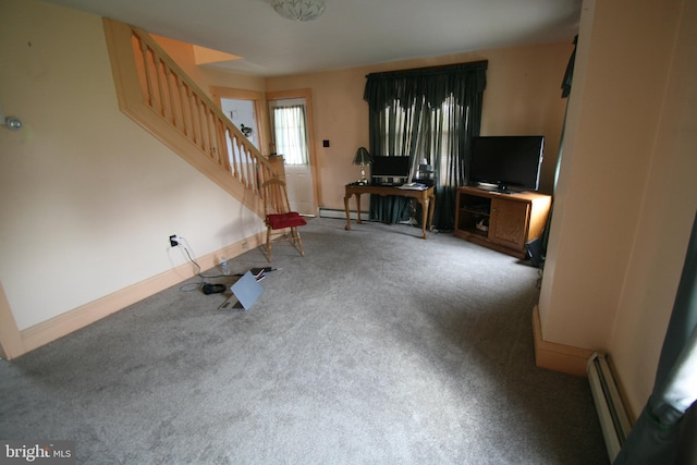 unfurnished living room featuring a baseboard radiator and carpet