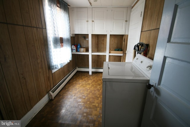 clothes washing area featuring washer / clothes dryer, wood walls, dark hardwood / wood-style floors, and a baseboard heating unit