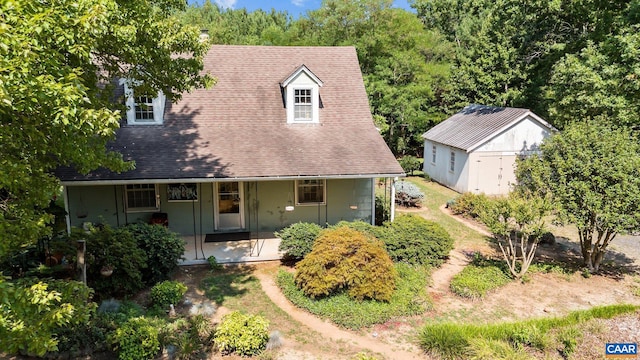 view of front of house with covered porch and a storage unit