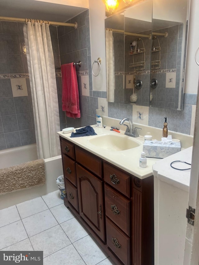 bathroom featuring vanity, shower / tub combo with curtain, tile patterned floors, and tile walls