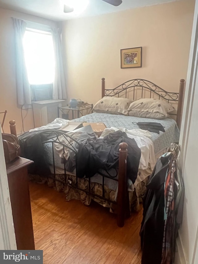 bedroom with hardwood / wood-style floors and ceiling fan