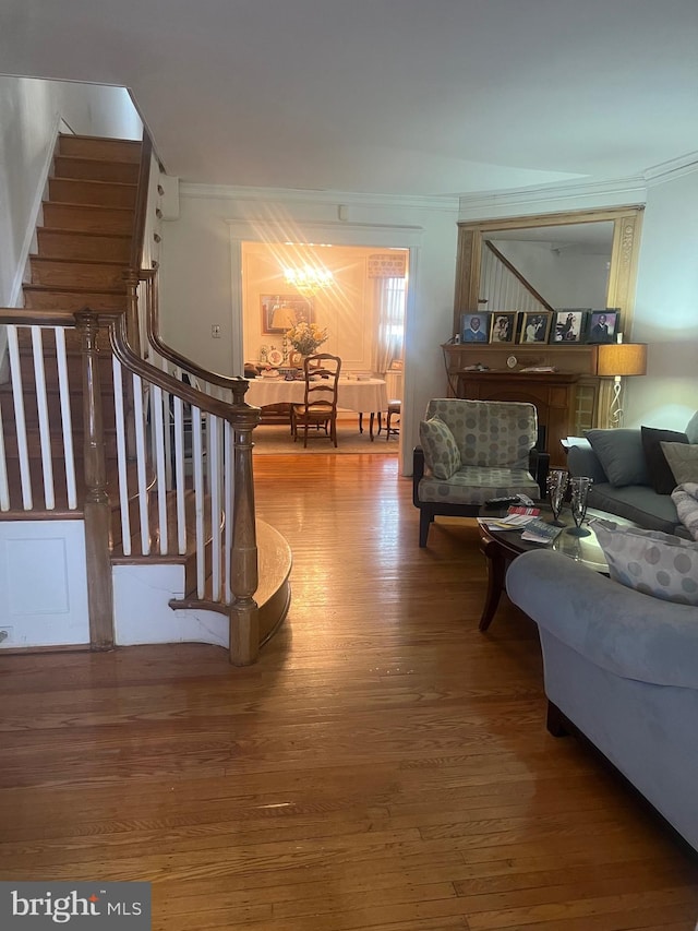 living room featuring crown molding and hardwood / wood-style flooring