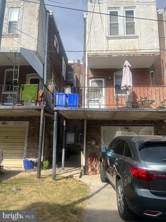 view of front of home with a balcony and a garage