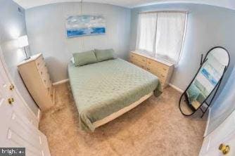 bedroom with light carpet, baseboards, and lofted ceiling