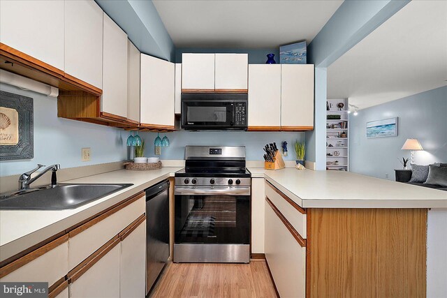 14301 Tunnel Ave Unit 2A, Ocean City, MD 21842 - kitchen featuring stainless steel range with electric stovetop, black microwave, a sink, a peninsula, and dishwasher