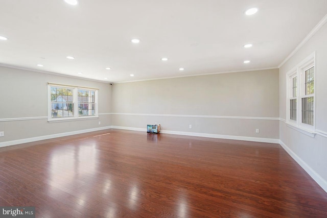 spare room with dark hardwood / wood-style floors and crown molding