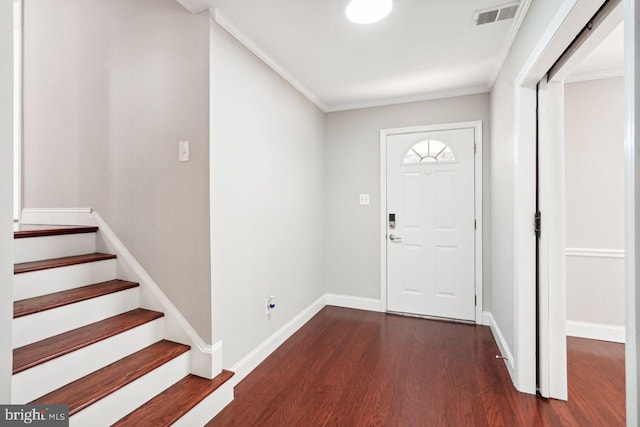 foyer featuring crown molding and dark hardwood / wood-style flooring