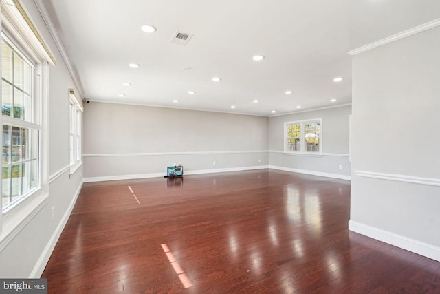 empty room featuring dark hardwood / wood-style floors and crown molding