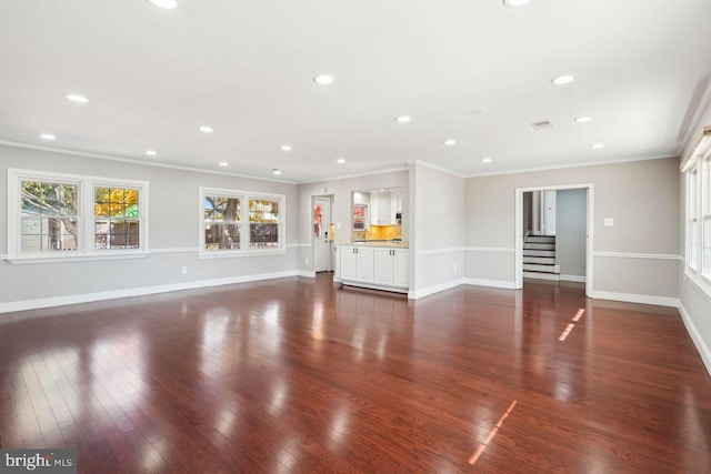 unfurnished living room with dark wood-type flooring and ornamental molding