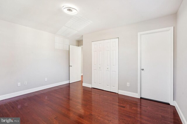 unfurnished bedroom featuring dark hardwood / wood-style floors