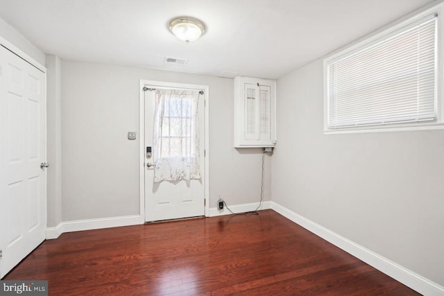 doorway with dark hardwood / wood-style floors