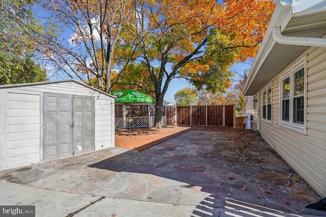 view of patio with a storage unit