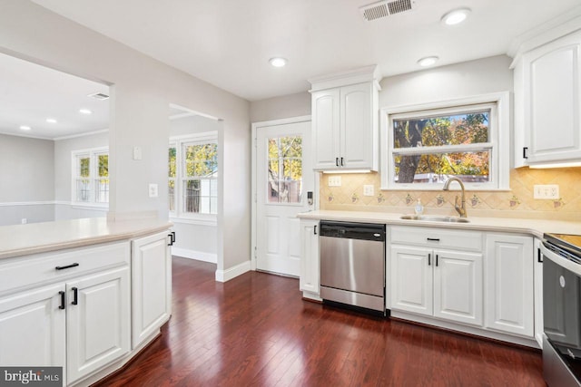 kitchen featuring stainless steel appliances, dark hardwood / wood-style floors, a wealth of natural light, sink, and white cabinets