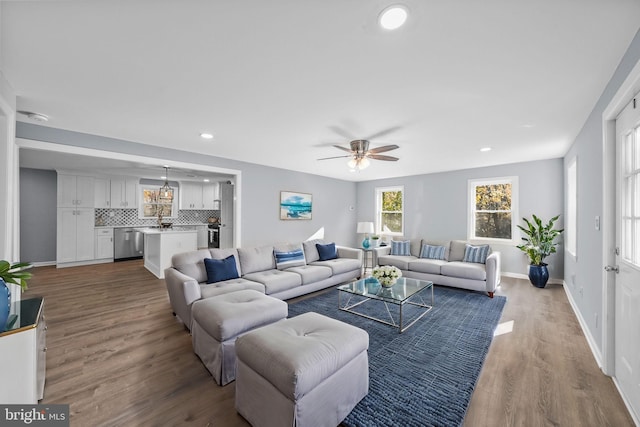 living room with hardwood / wood-style floors and ceiling fan