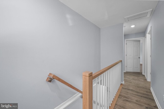 corridor with hardwood / wood-style flooring