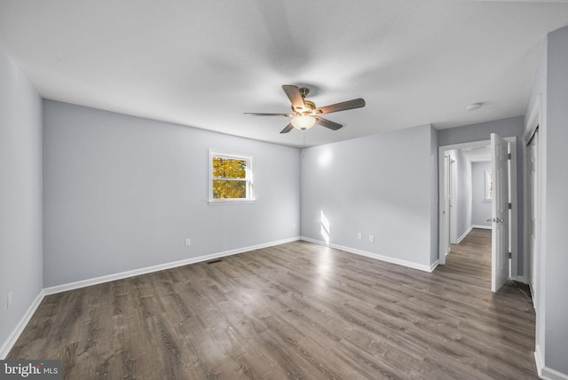 spare room with ceiling fan and dark hardwood / wood-style floors