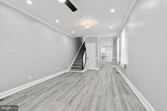 unfurnished living room featuring crown molding and light hardwood / wood-style flooring