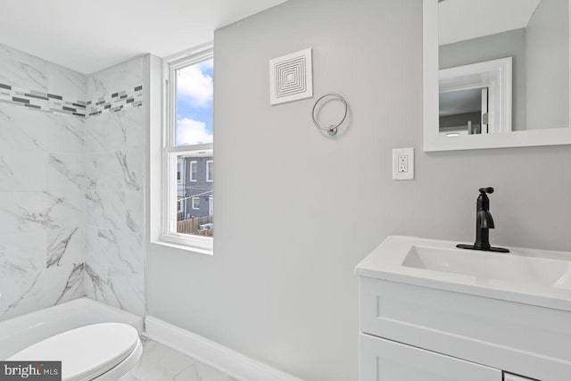 bathroom with vanity, toilet, and a tile shower