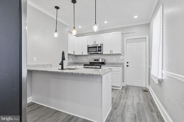 kitchen with white cabinetry, light stone countertops, appliances with stainless steel finishes, and light hardwood / wood-style floors