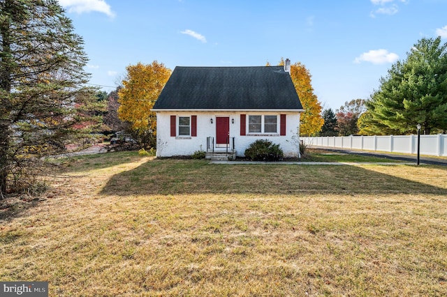 new england style home featuring a front yard