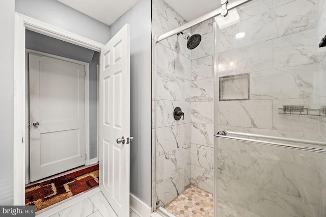 bathroom featuring a shower with door