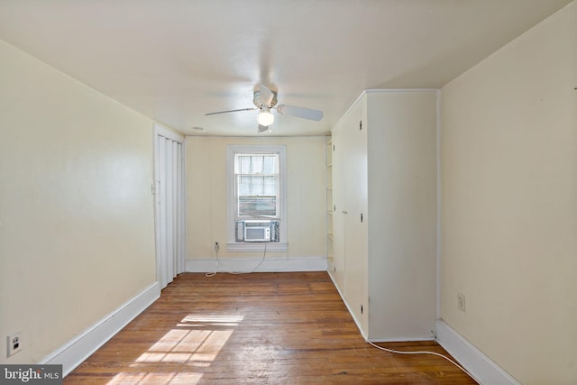 unfurnished room with cooling unit, hardwood / wood-style flooring, and ceiling fan