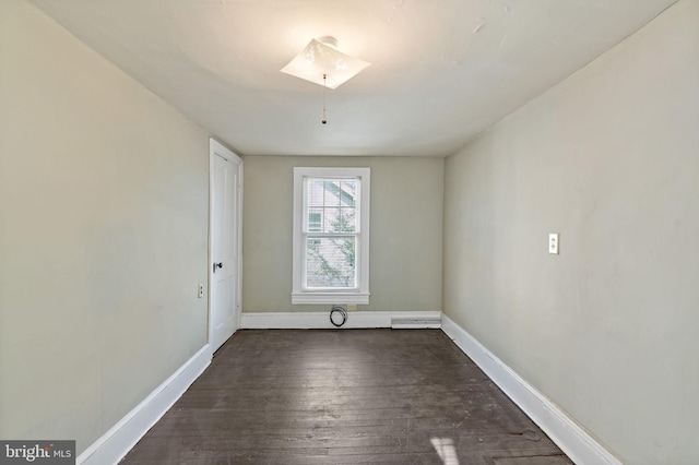 spare room with dark wood-type flooring