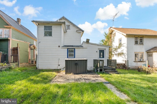 back of house with a lawn