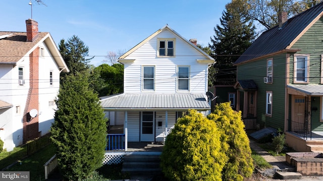 view of front of home with a porch and cooling unit