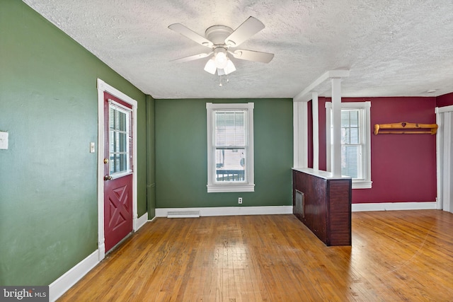 entryway featuring light hardwood / wood-style floors, a textured ceiling, plenty of natural light, and ceiling fan