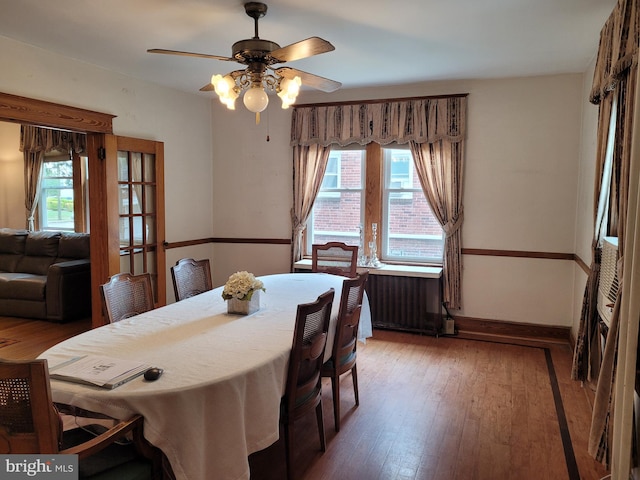 dining room with hardwood / wood-style flooring and ceiling fan