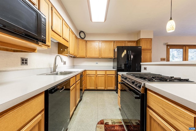 kitchen featuring black appliances, sink, and decorative light fixtures