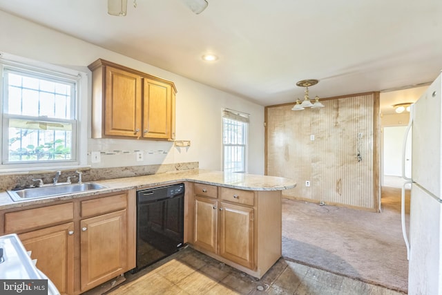 kitchen with kitchen peninsula, black dishwasher, sink, and plenty of natural light