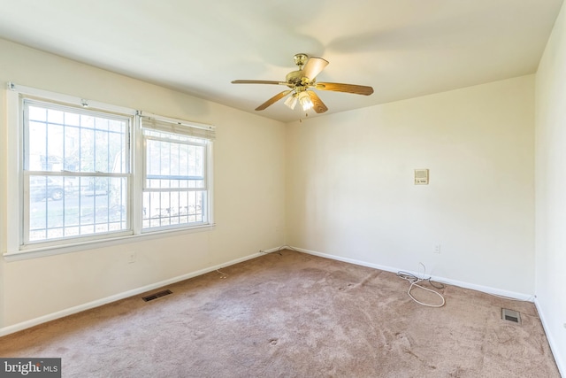 unfurnished room with ceiling fan and light colored carpet