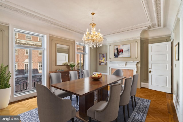 dining space with parquet floors, a notable chandelier, a healthy amount of sunlight, and crown molding