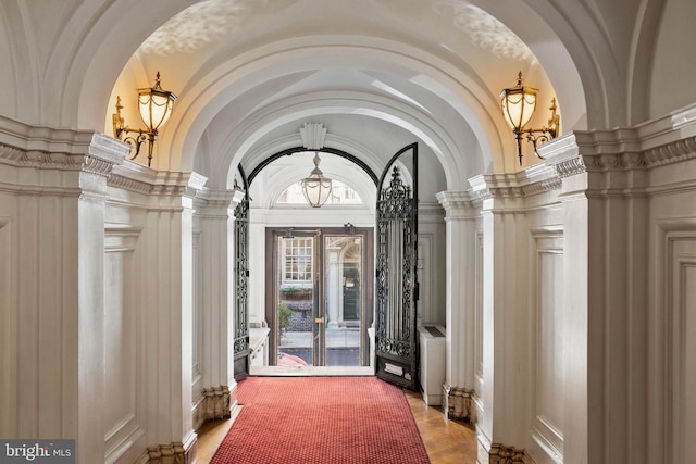 doorway to outside featuring a towering ceiling, french doors, and wood-type flooring