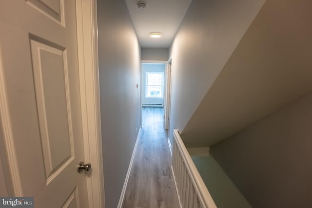 corridor with a baseboard radiator and light wood-type flooring