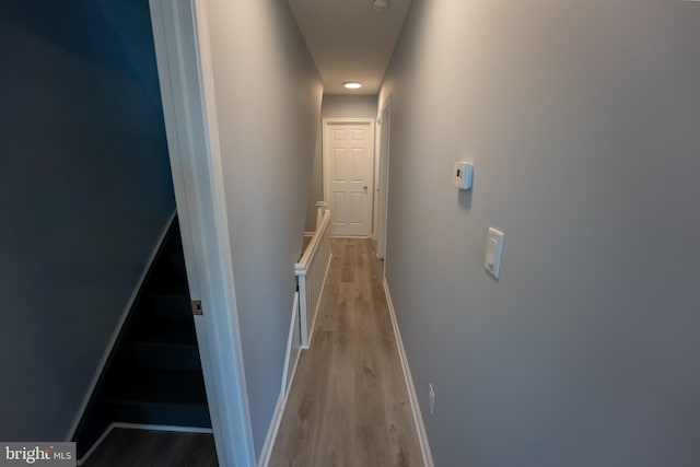 hallway with light hardwood / wood-style floors