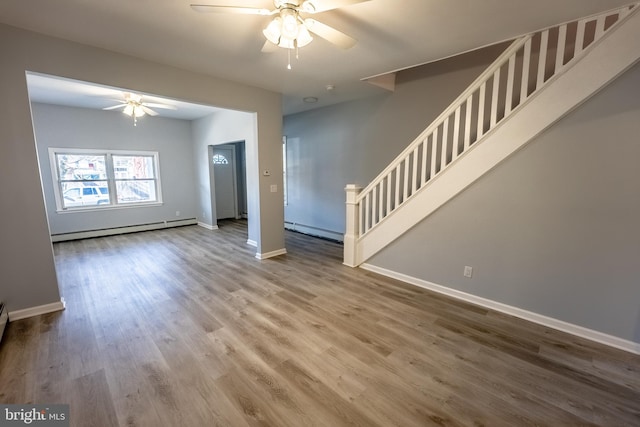 unfurnished living room with hardwood / wood-style floors, baseboard heating, and ceiling fan