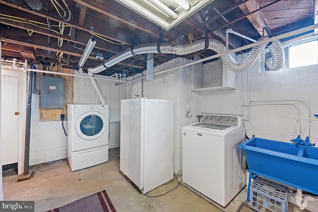 laundry room with sink, electric panel, and separate washer and dryer