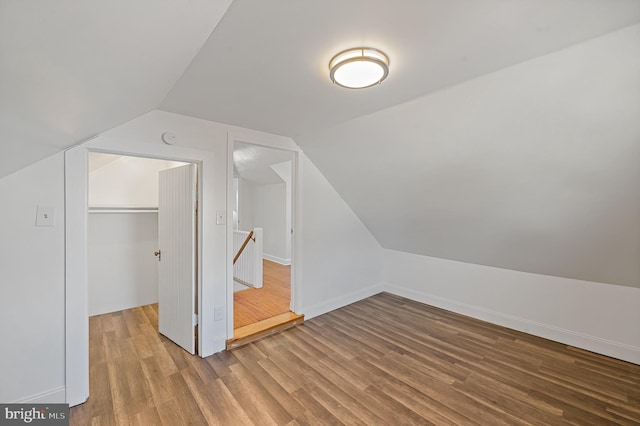 bonus room with lofted ceiling and hardwood / wood-style floors