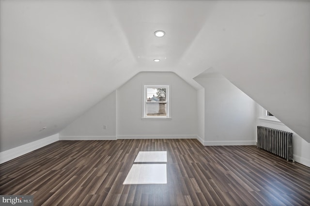 bonus room with radiator, lofted ceiling, and dark hardwood / wood-style flooring