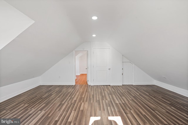 bonus room with lofted ceiling and dark hardwood / wood-style floors