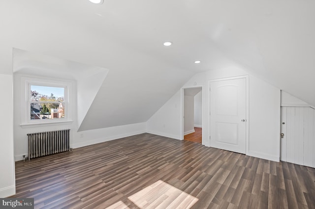 bonus room featuring radiator, dark wood-type flooring, and lofted ceiling