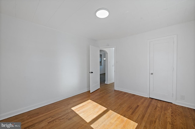 unfurnished room featuring wood-type flooring