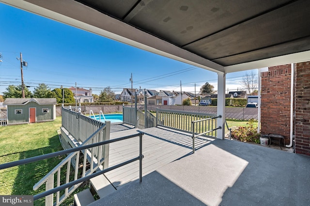 view of patio / terrace featuring a shed and a fenced in pool