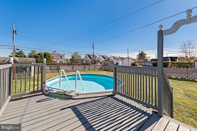 view of pool featuring a deck and a yard