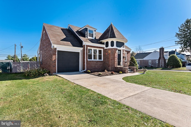 view of front of home with a front yard and a garage