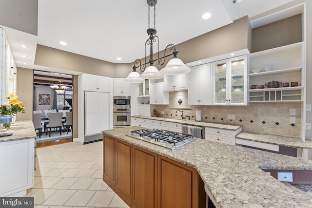 kitchen with stainless steel appliances, backsplash, light stone countertops, decorative light fixtures, and white cabinets