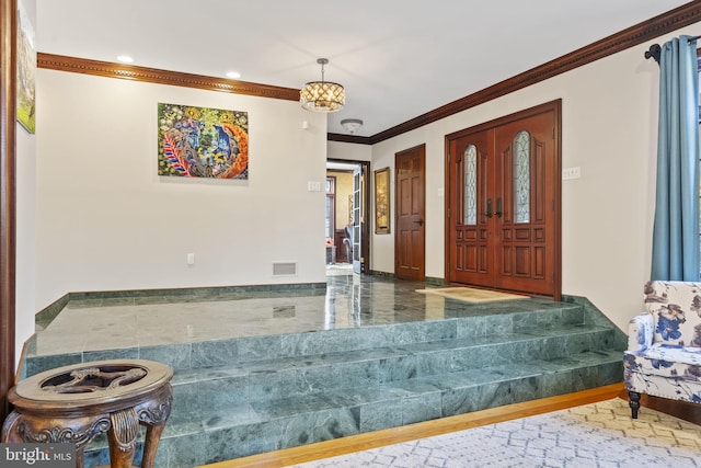 foyer featuring ornamental molding